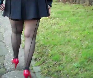 Black seamed fishnet stockings and Red Heels
