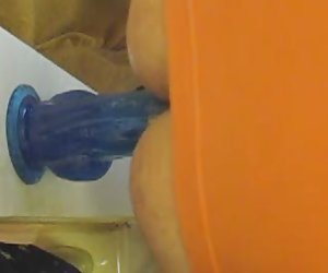 Chastity tranny fucks 9 inch wall dildo